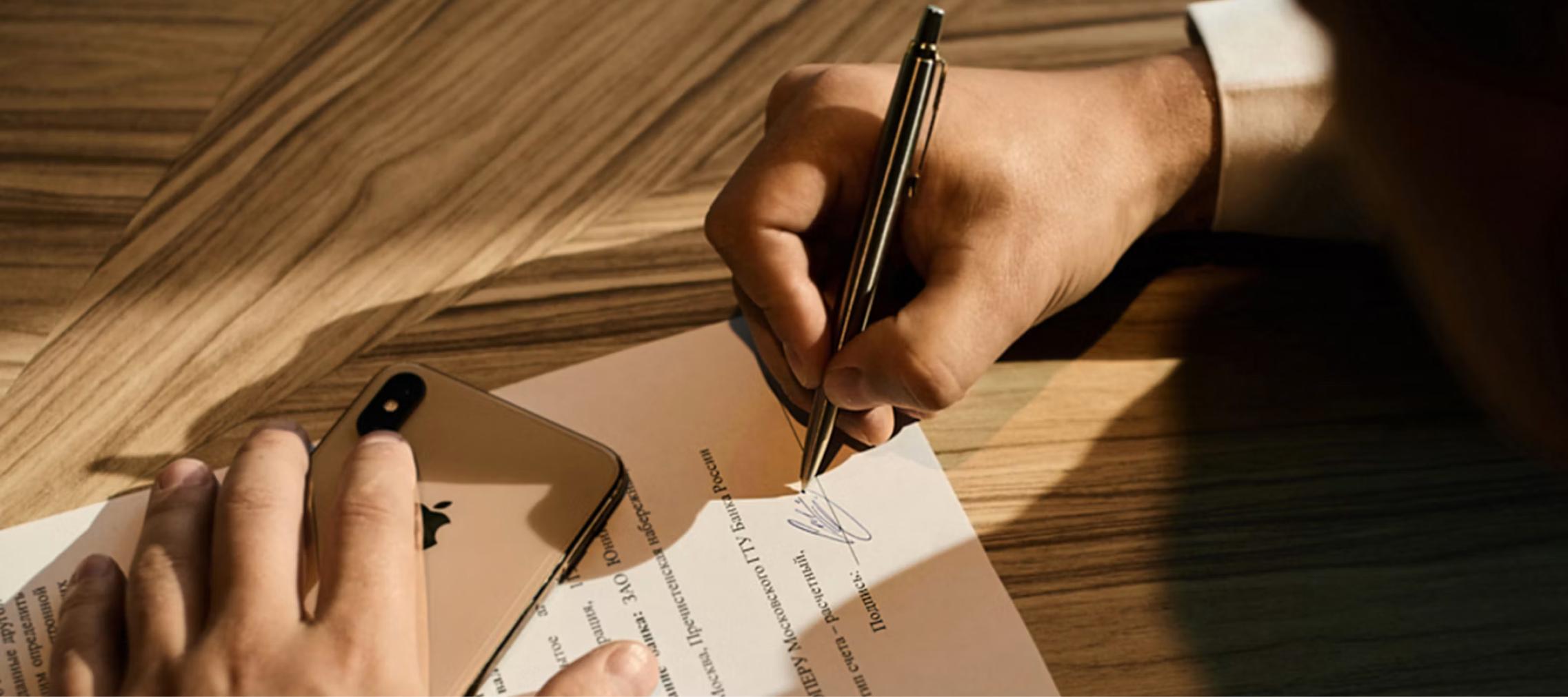 dispute resolution Dispute resolution: hand signing a document with a pen