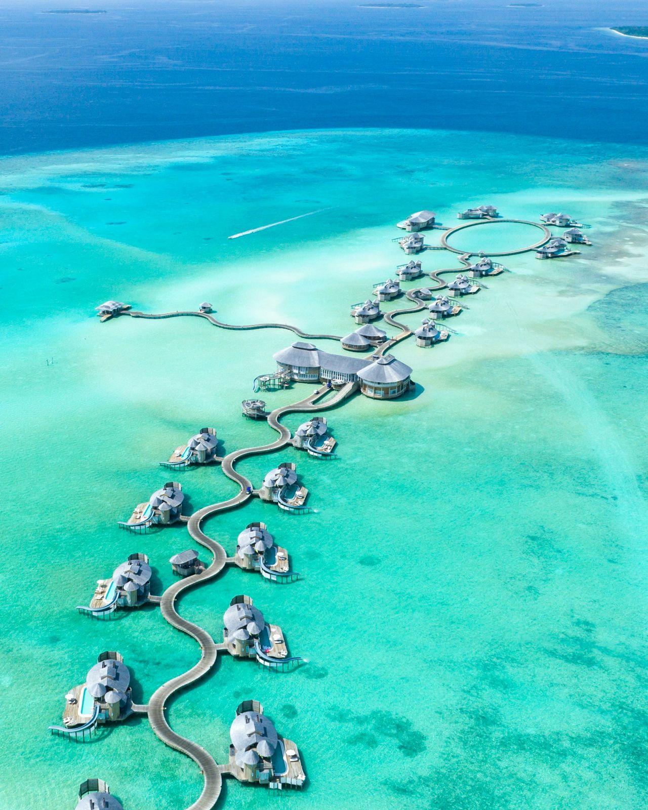hospitality Hospitality law: overwater villas connected by walkways in a Maldivian lagoon