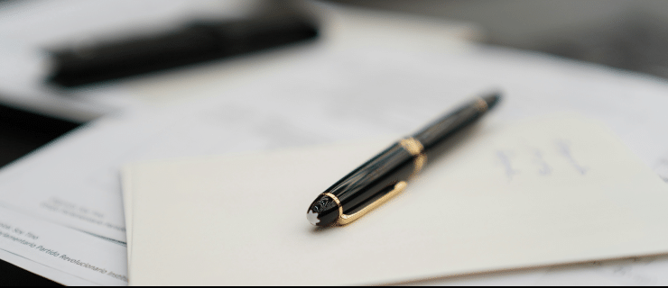 tax Tax advisory: fountain pen resting on papers